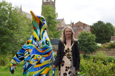 The Mayor of Worcester standing next to a painted model of a penguin