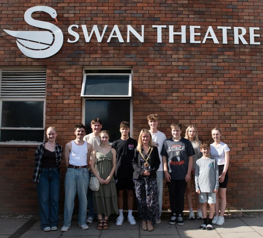 The Mayor and young performers standing outside the Swan Theatre