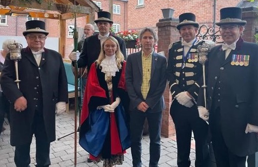 The Mayor and her macebearers standing in a row