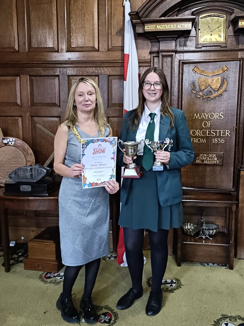 The Mayor presenting a certificate to a girl in school uniform