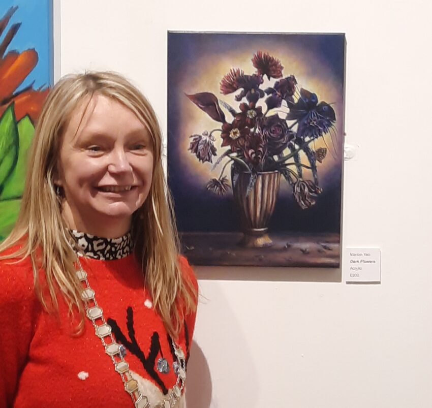 The Mayor standing next to a painting of Dark Flowers