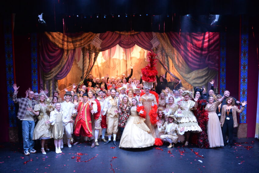 The cast of Beauty And The Beast on stage, with the Mayor standing with them in the front row